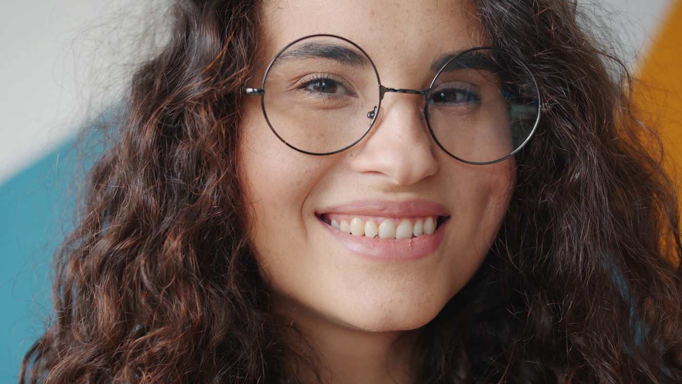 Young woman with glasses smiling